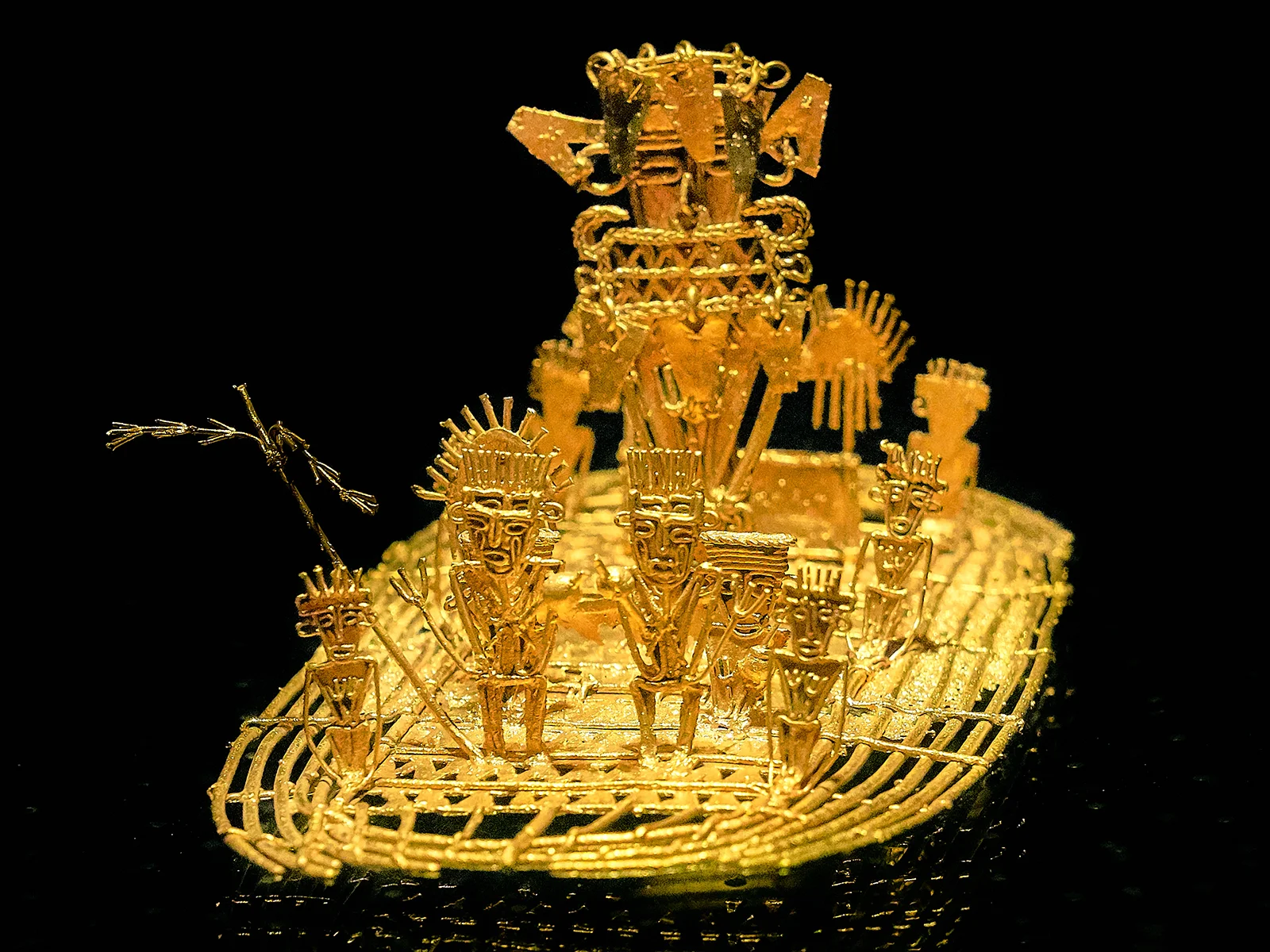 Gold Muisca votive raft depicting a central figure surrounded by attendants